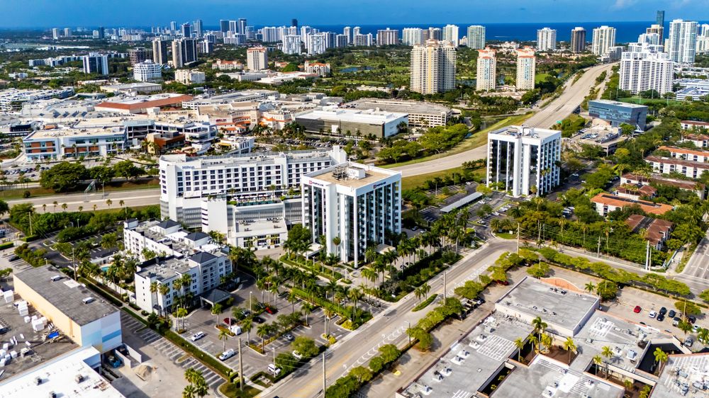 Wide aerial panorama of coastal city showing urban development and waterfront.