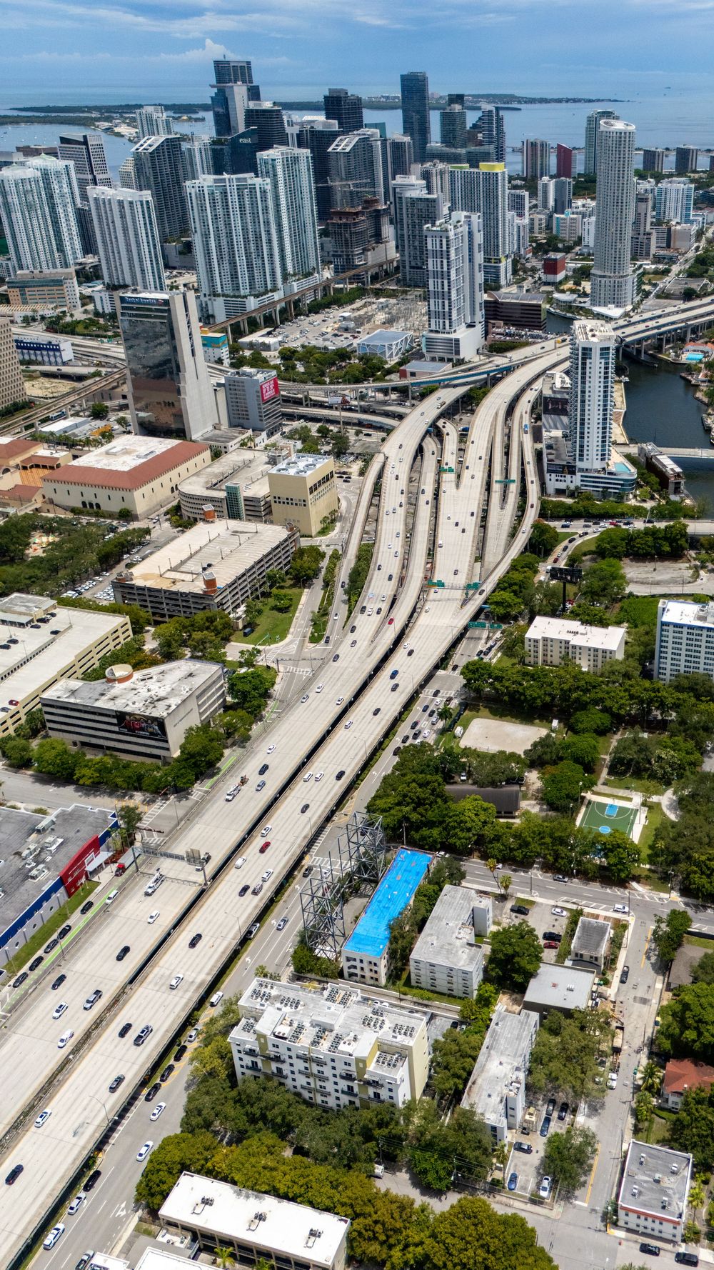 Aerial view of downtown Miami with major highway interchange and high-rise buildings.