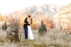 A romantic scene against mountain backdrop during golden hour.