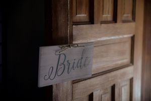 Rustic wooden signs with elegant script lettering for wedding decor.