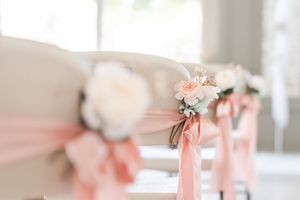 Elegant pink and white wedding reception table decorations with floral centerpieces.