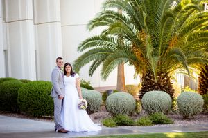 Newlyweds share intimate moments among palm trees and landscaped gardens.