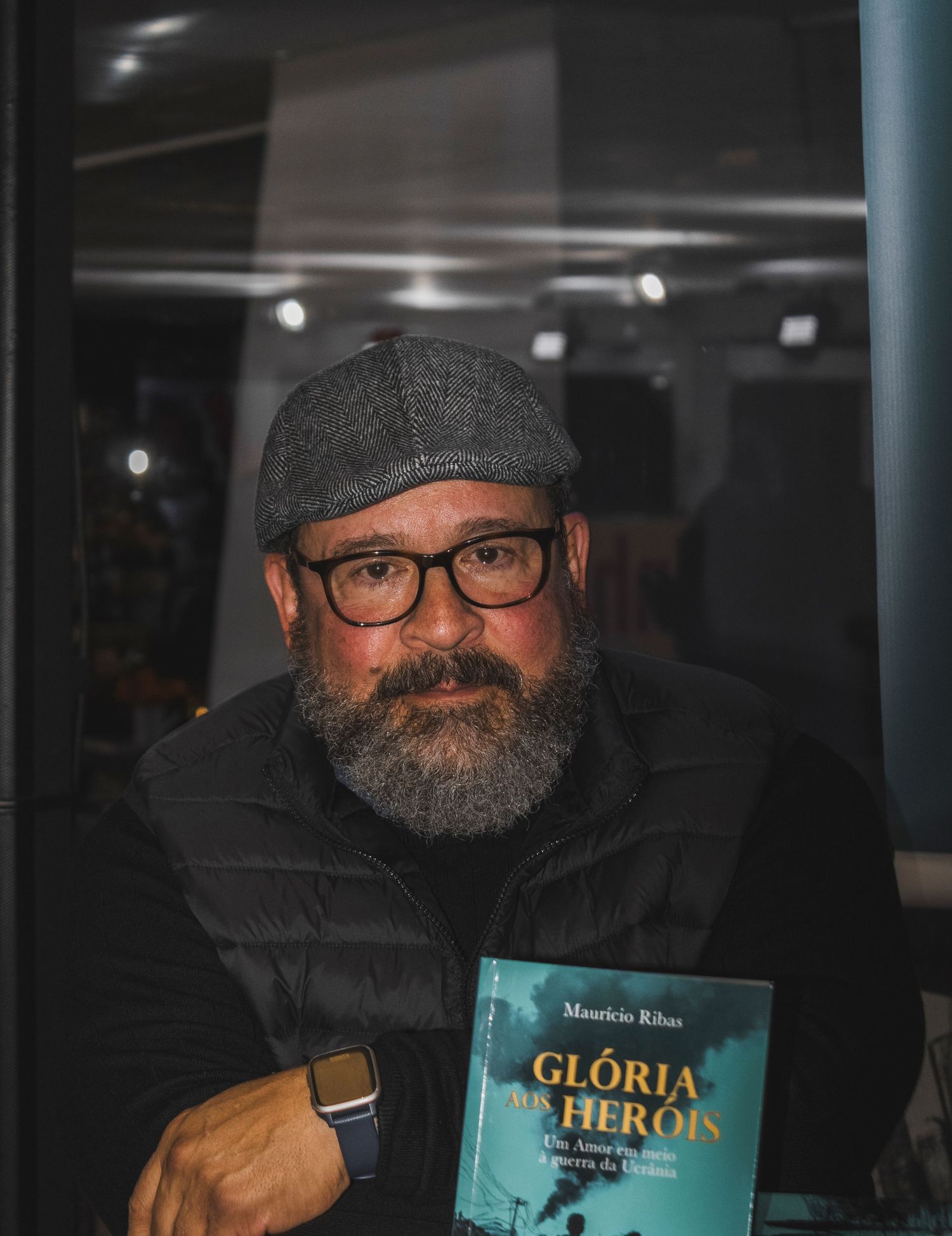 Portrait of author holding book at literary event photography by Piret Victoria Ribas.