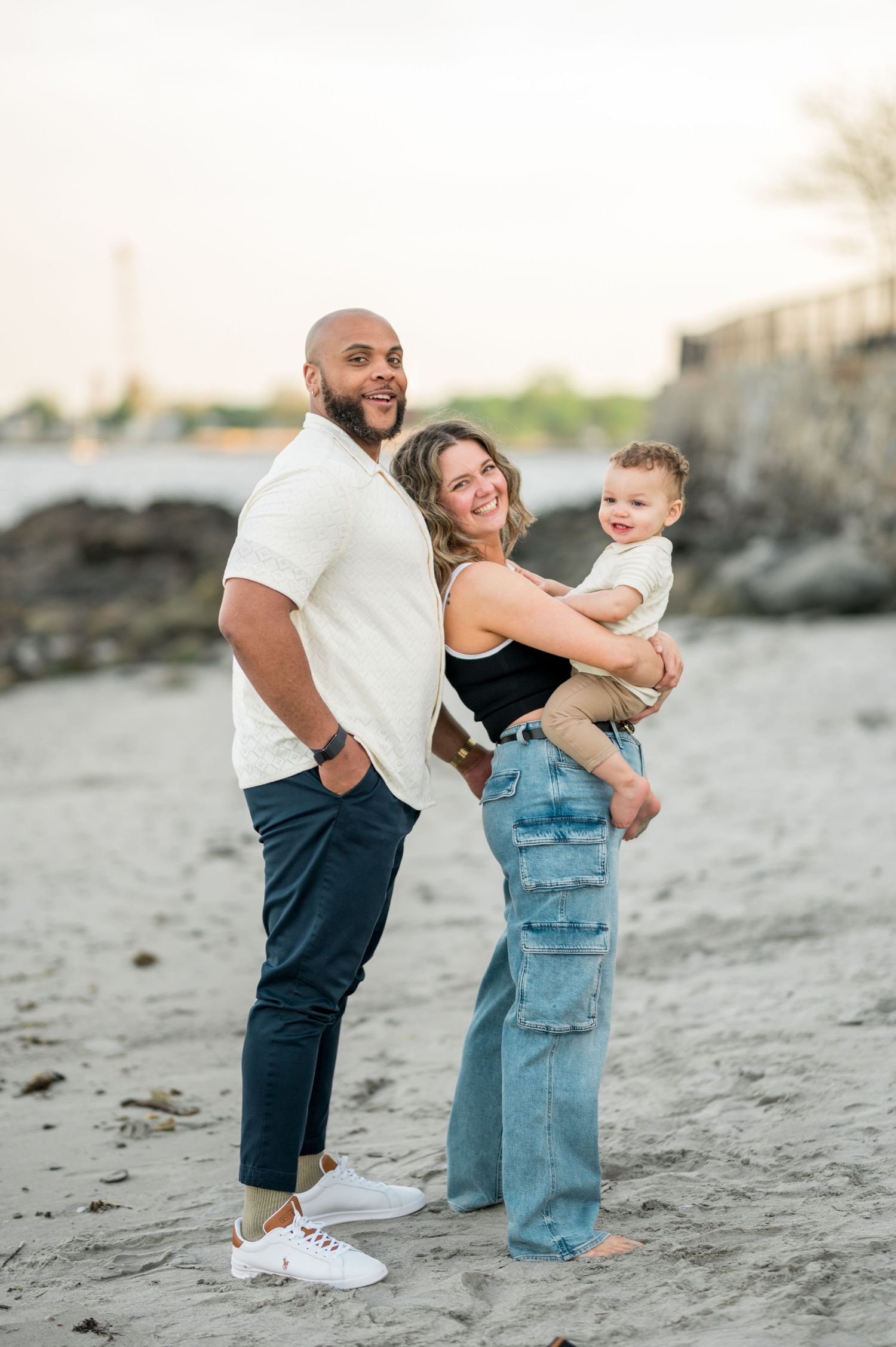 A playful sequence of three family photos showing joyful moments at sunset on a rocky beach.