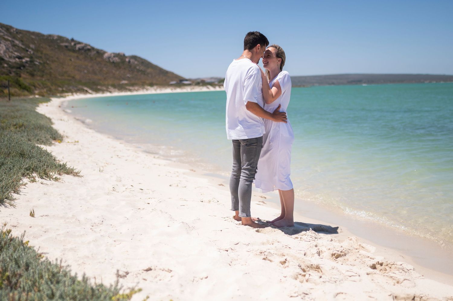 Couple sharing romantic moments at scenic beach locations captured in multiple connected photographs.