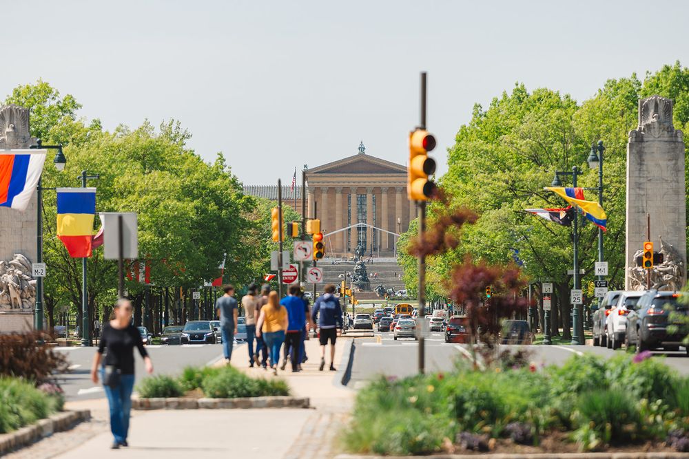 View down Benjamin Franklin Parkway towards Philadelphia Museum of Art with international flags lining the street.