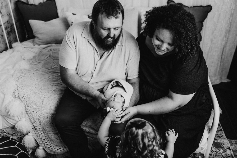 Candid black and white family photos showing intimate moments and genuine emotions.