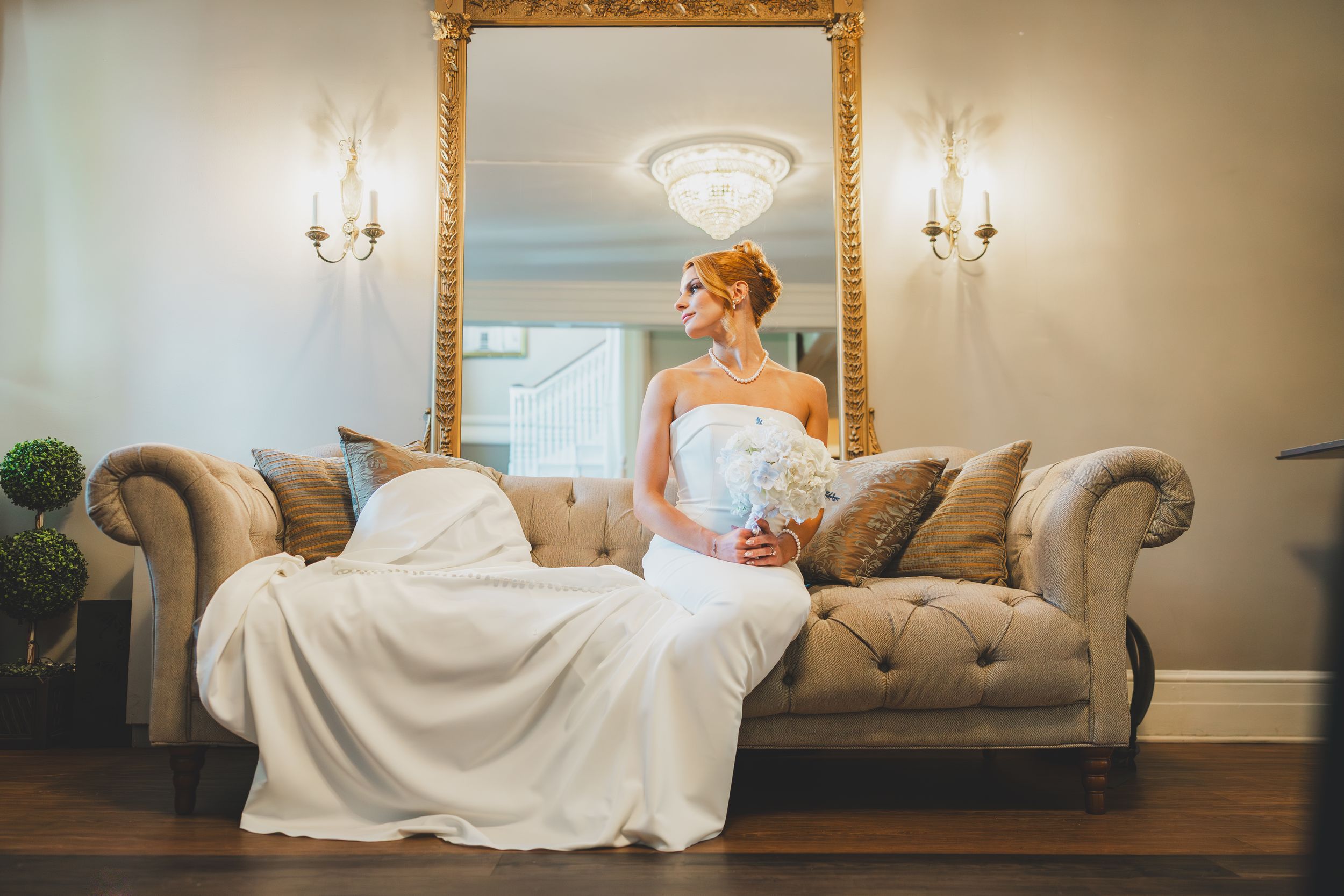 Editorial bridal pose on the couch at the Overhills Mansion in Catosville, Maryland