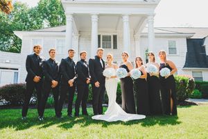 Wedding party poses together on green lawn of the Overhills Mansion in Catosville, Maryland
