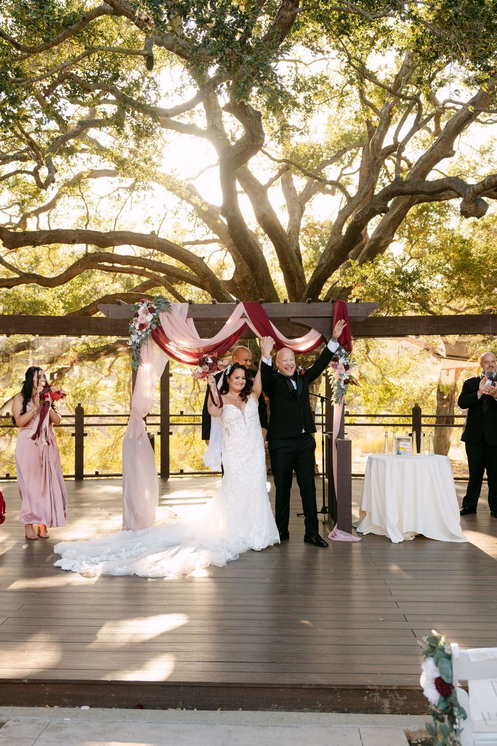 Wedding ceremony sequence captured at sunset under majestic oak trees on an outdoor wooden deck.