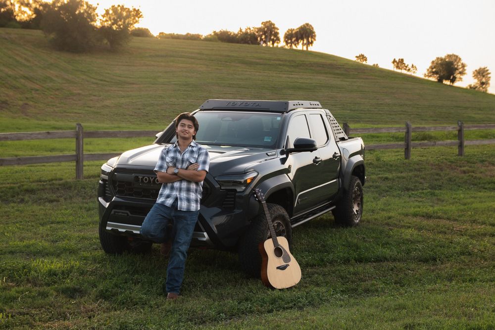 Graduate with Toyota Tacoma at Celery Fields in Sarasota, Florida senior photography session.