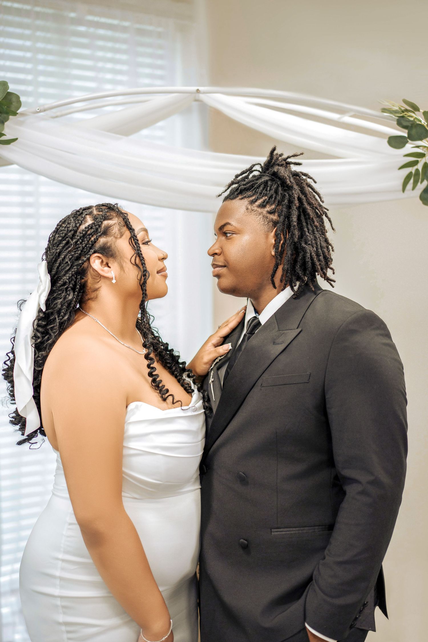 A romantic photoshoot showing tender moments between a couple in formal wedding attire.
