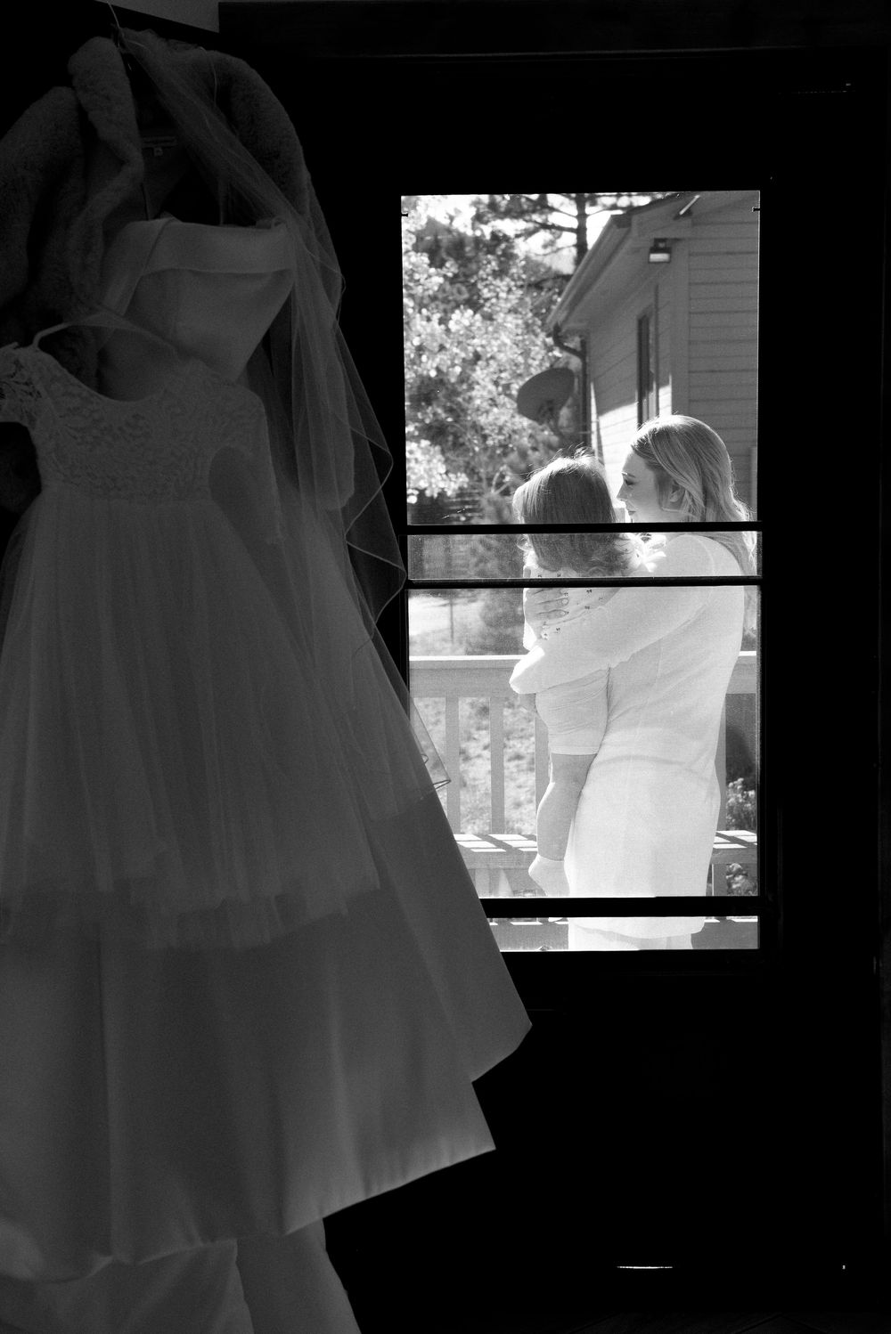 A series of black and white photographs showing the silhouette and details of a flowing white wedding dress.