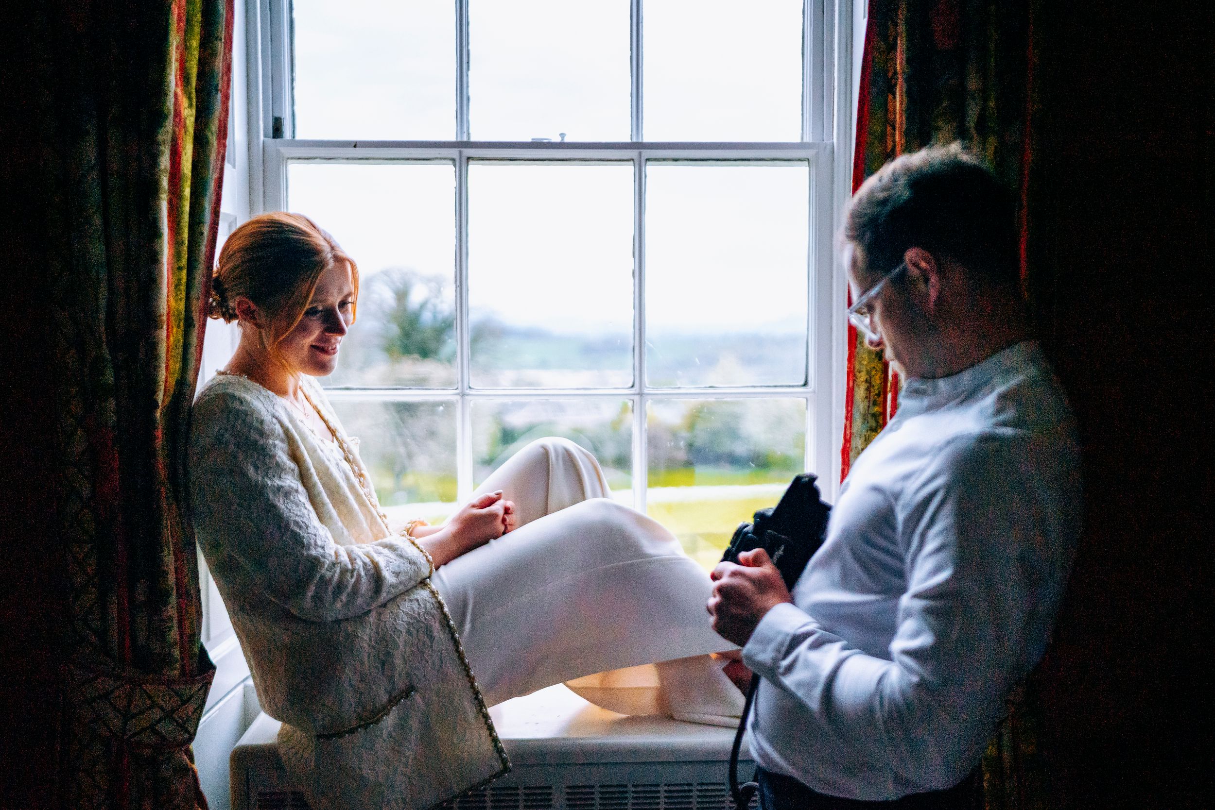 Groom taking a photo of the bride on film with his medium format camera