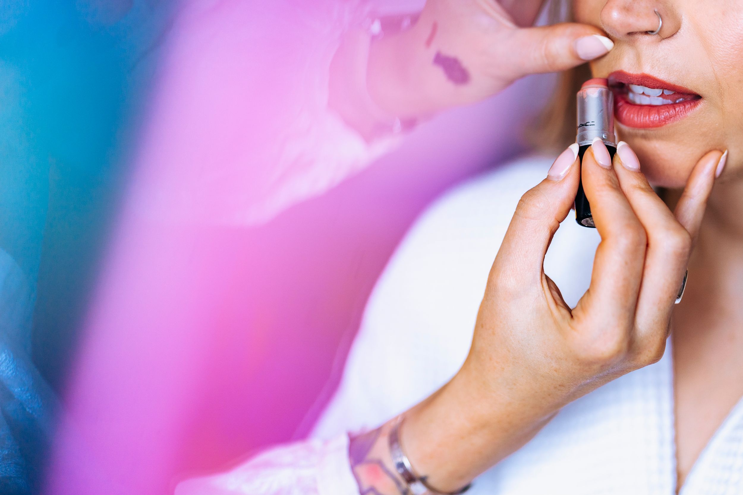 Bride having make up put on, colourful close up of lips at liverpool wedding