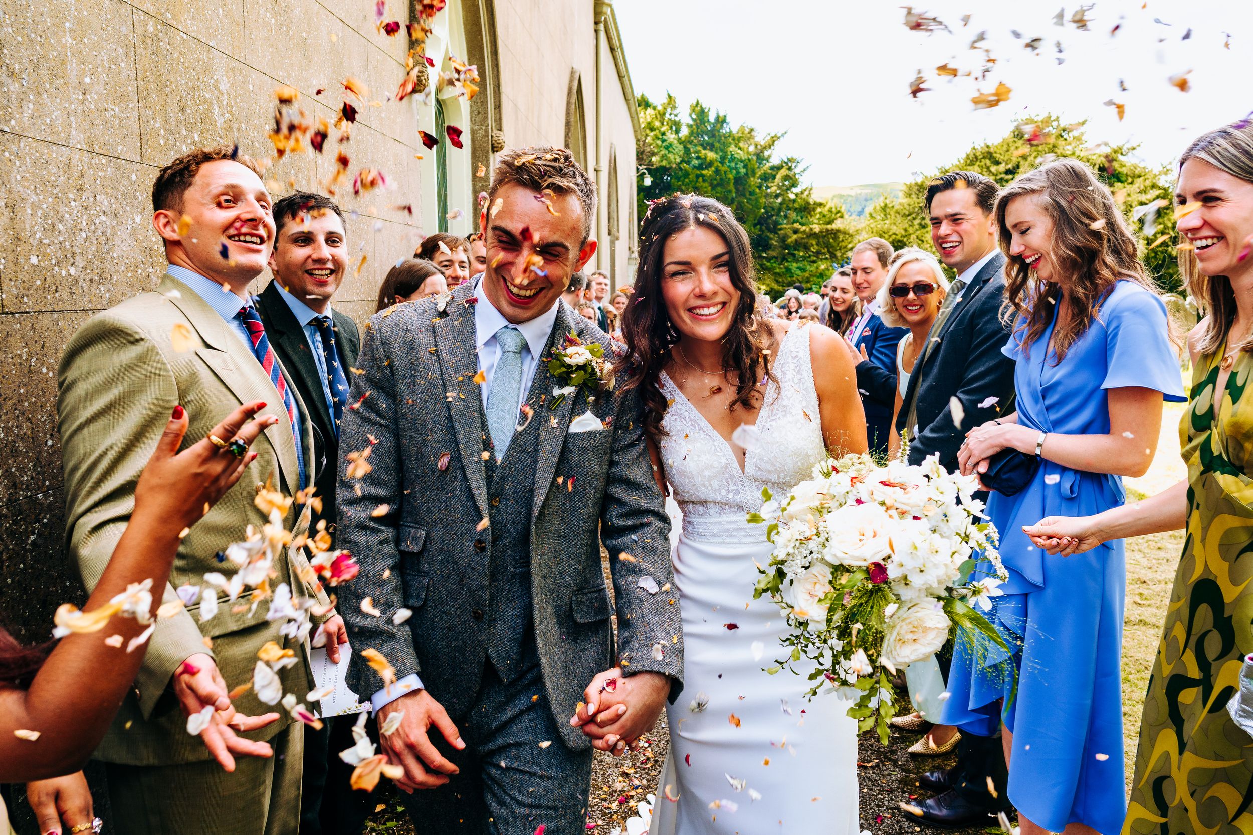 Bride and groom exiting the church with a confetti run