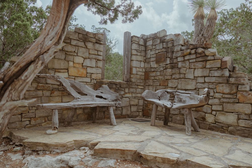 Ancient stone walls and pathways wind through a rustic outdoor space.