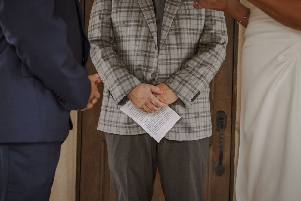 Wedding party members in formal attire gathered for ceremony preparations.