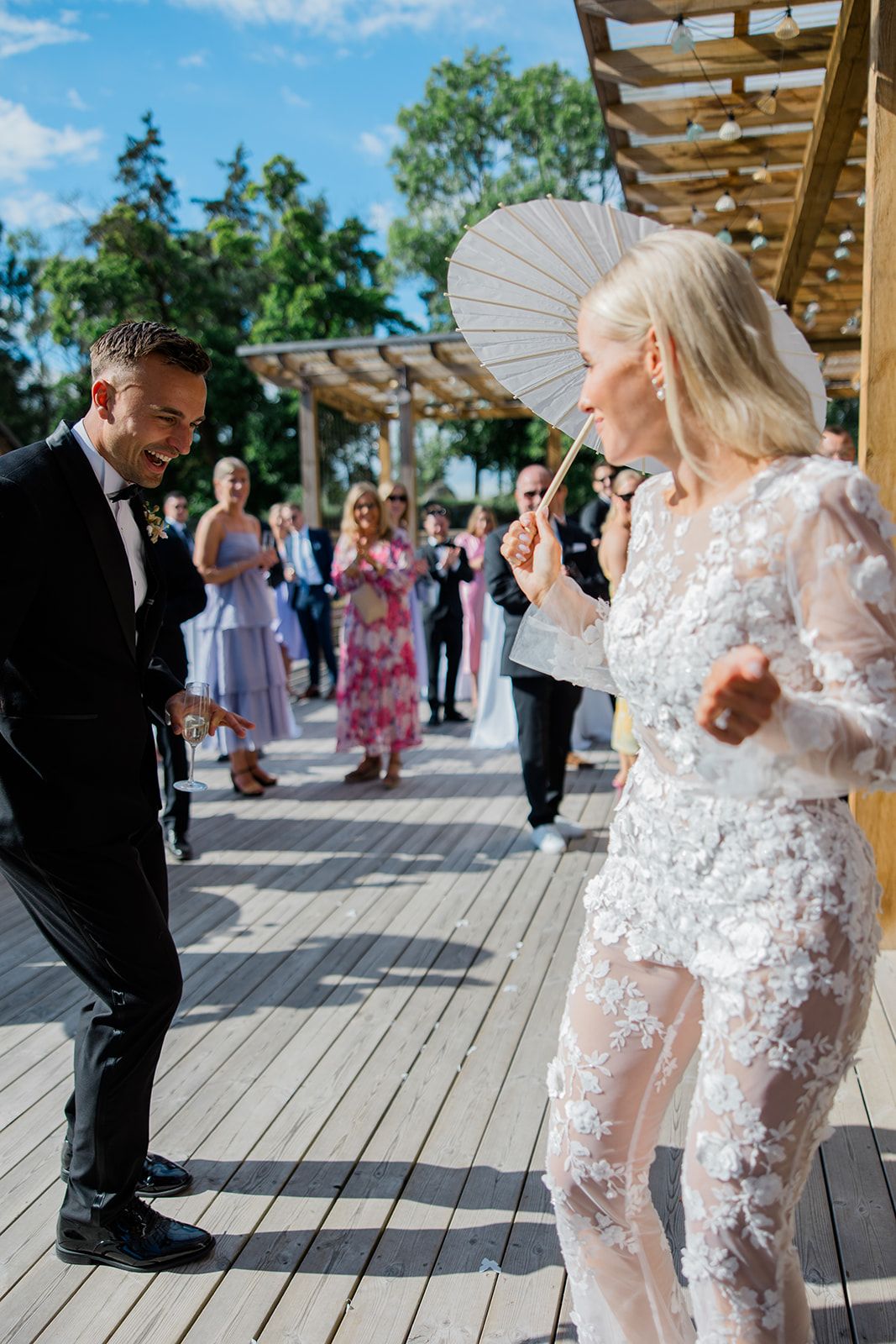 A sequence of candid wedding photos shows a couple sharing playful moments on a wooden deck outdoors.