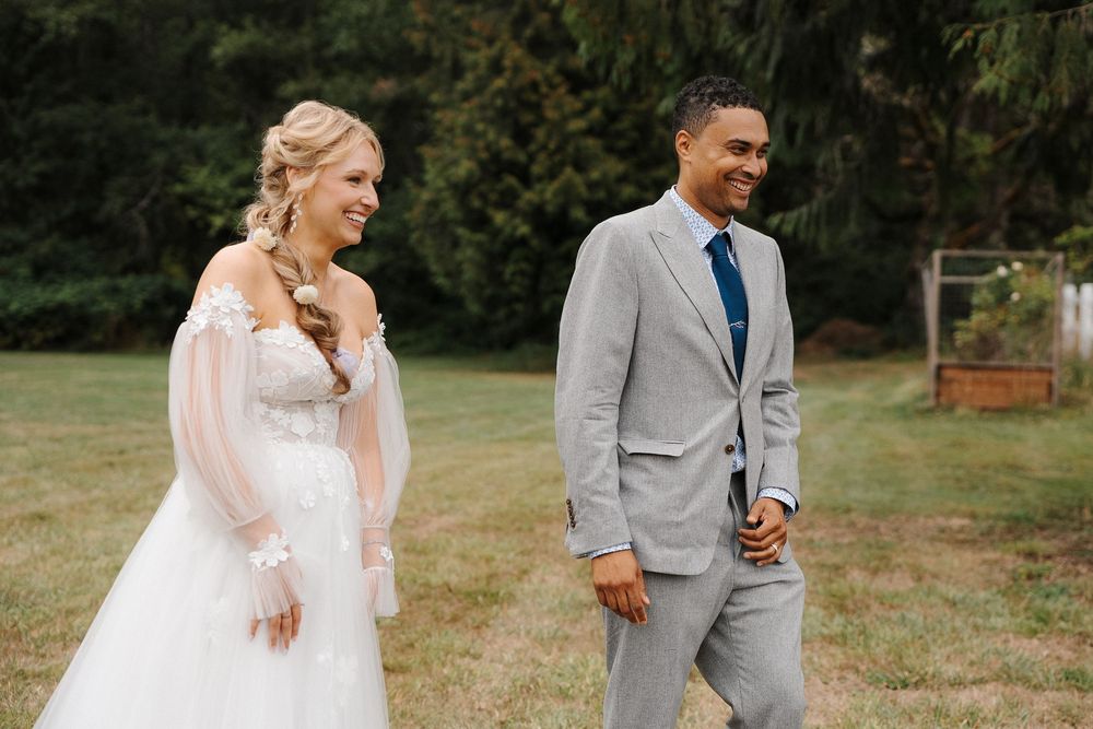 Couple sharing a romantic moment outdoors in a rustic countryside setting with natural greenery.