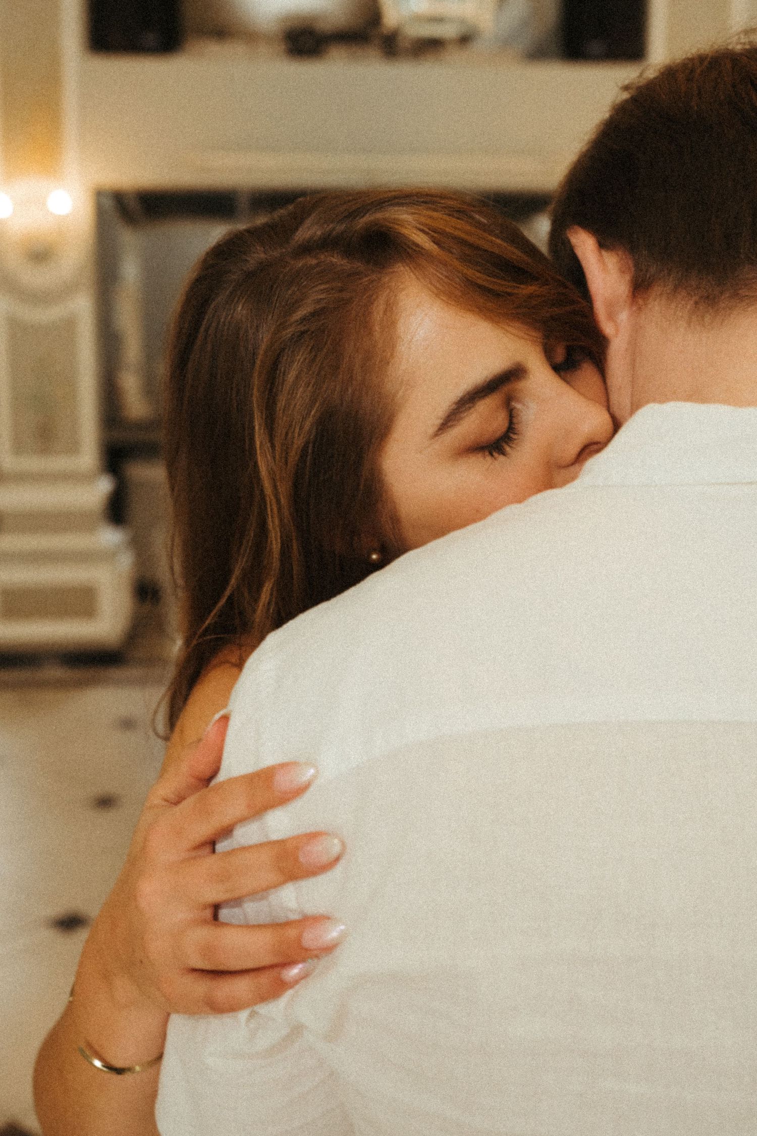 Close-up series of gentle embraces in soft indoor lighting.