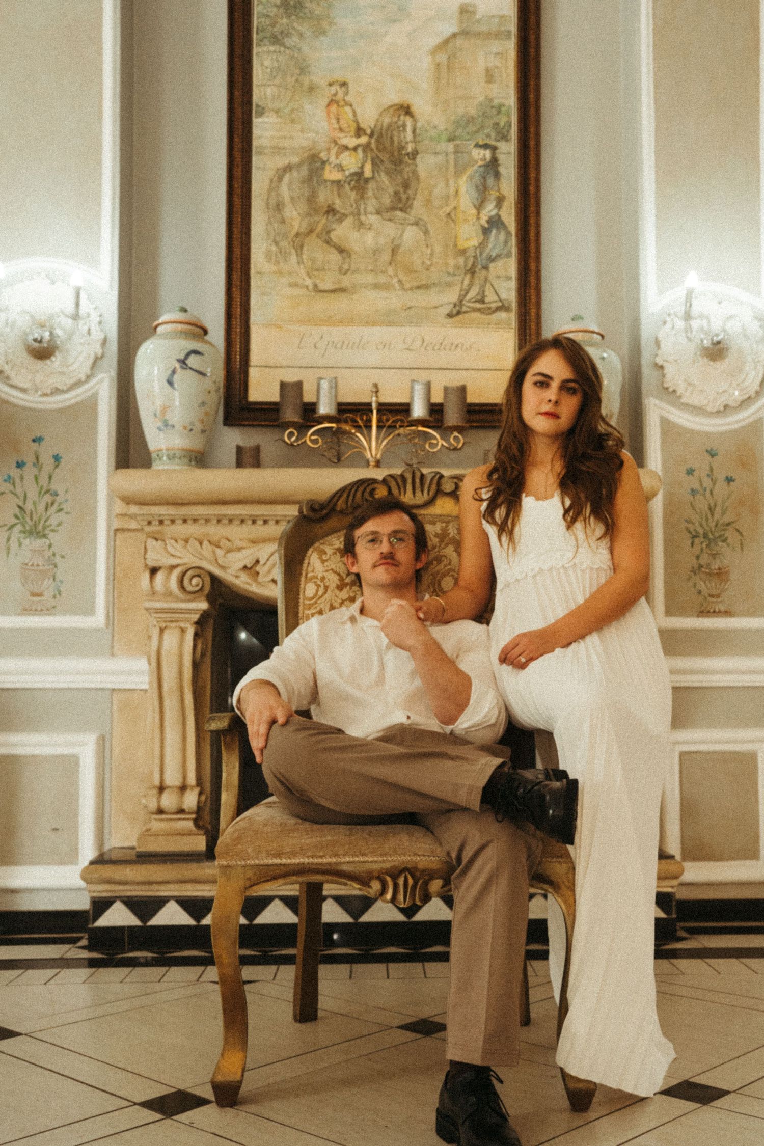 Dancing figures pose dramatically in an ornate room with vintage decor.