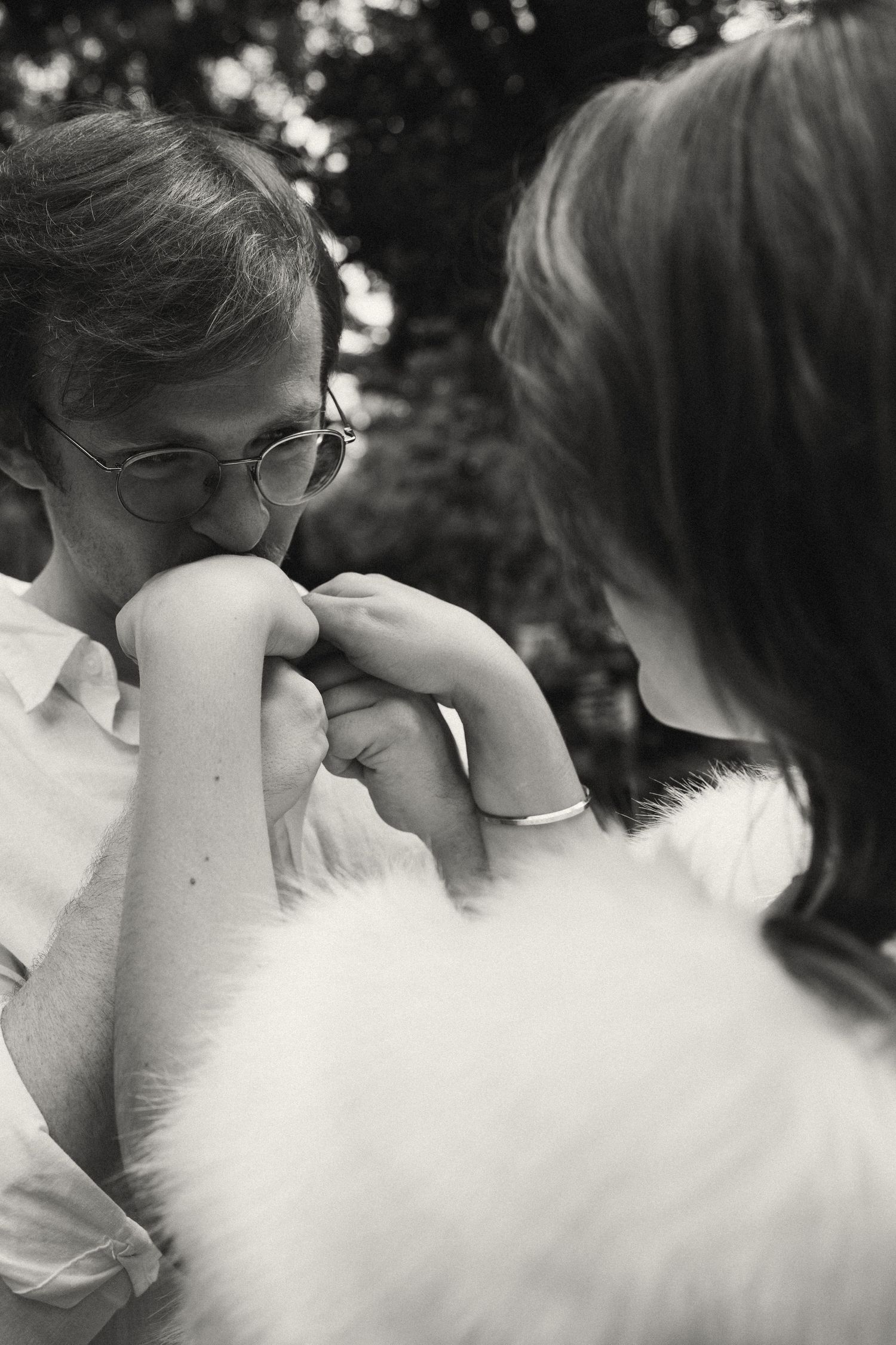 Intimate black and white portrait series showing gentle affection between two people.