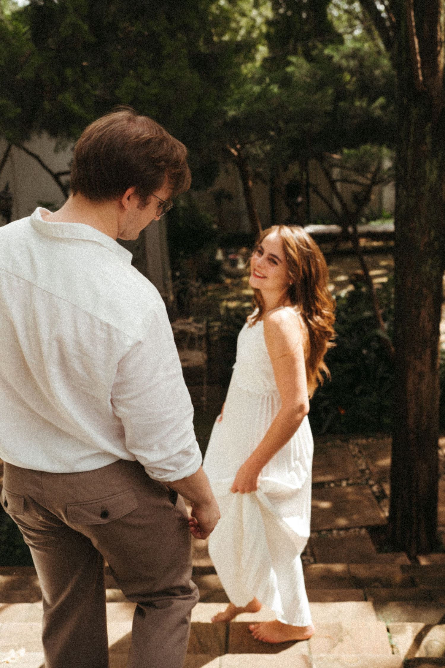 A romantic dance sequence captured in sepia tones showing graceful movement outdoors.