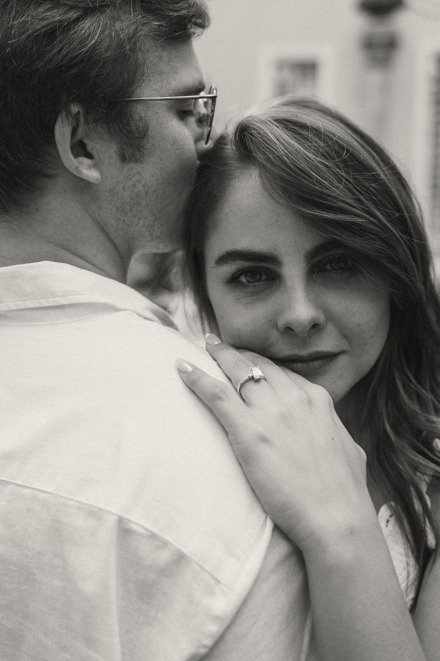 An intimate black and white portrait series showing tender moments between a couple.