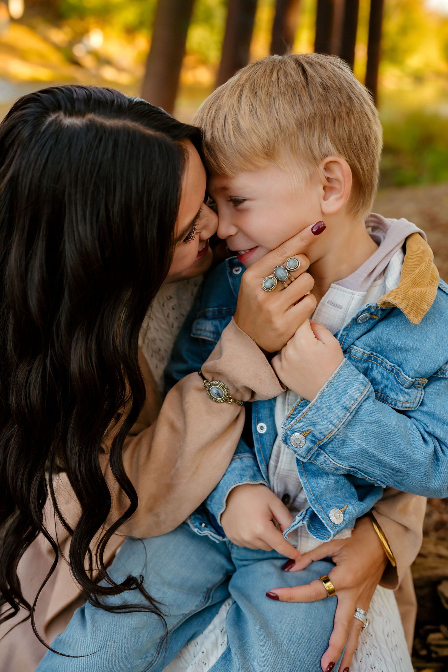 A tender moment between parent and child wearing denim jackets in warm golden sunlight.