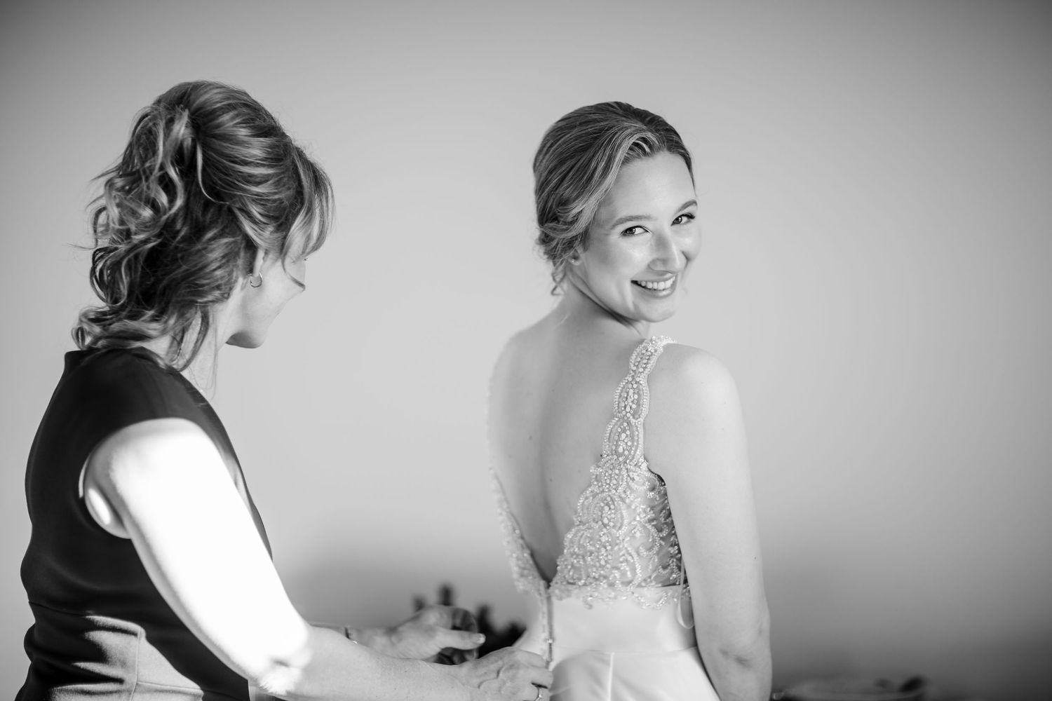 A series of black and white wedding preparation photos showing a bride getting ready for her special day.