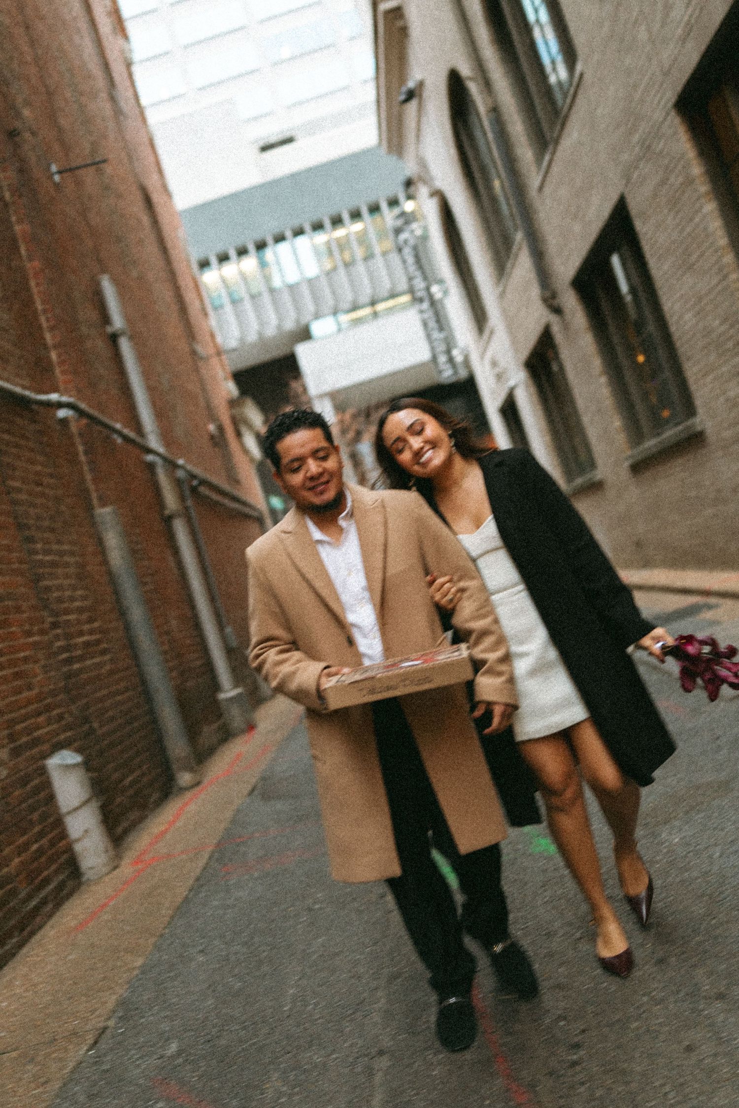 Nashville elopement photographer Karla Derry, happy couple walking on alley way holding pizza box