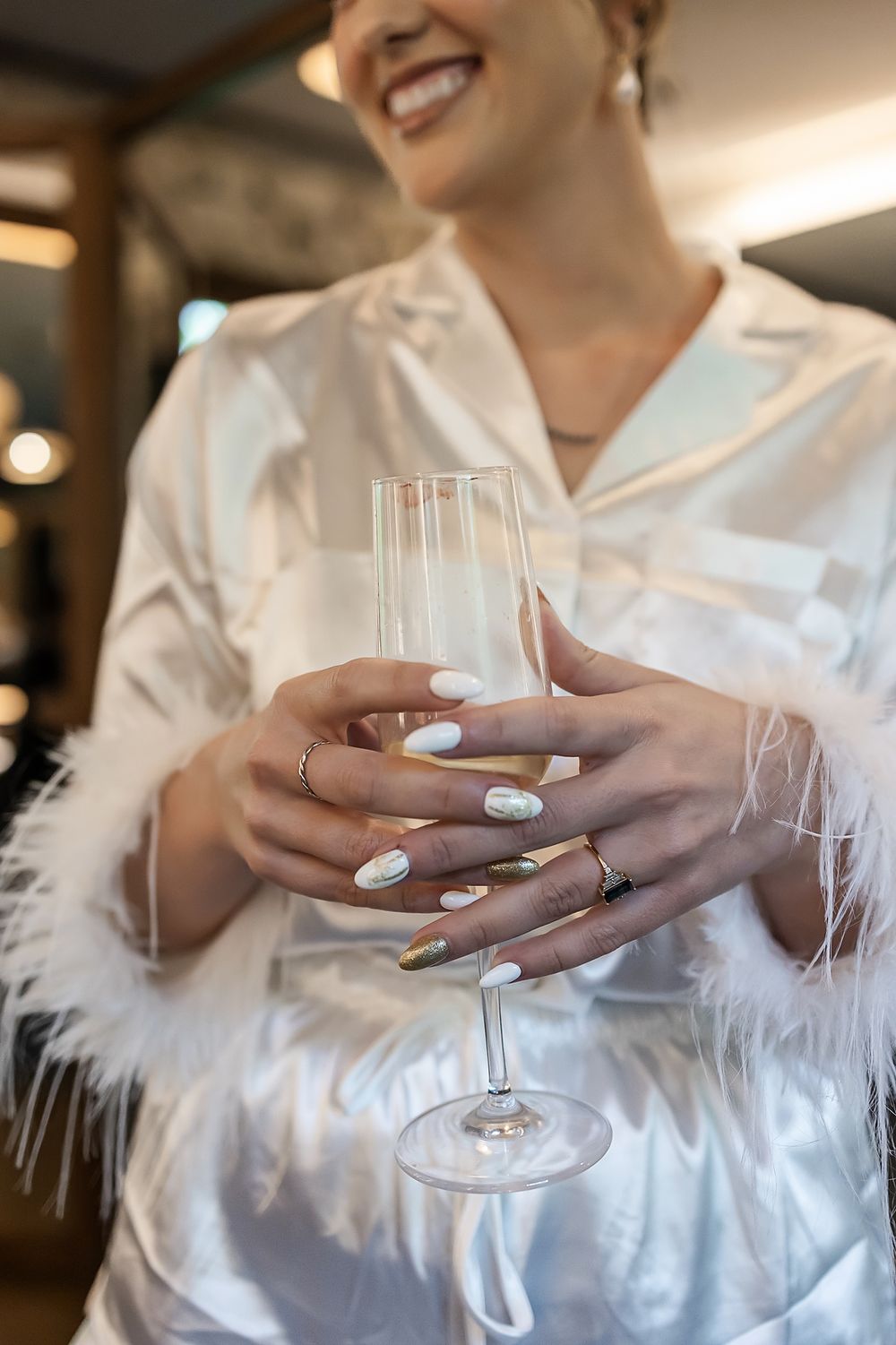 Bride holding champagne while getting ready at Secrets Moxché Playa del Carmen wedding.