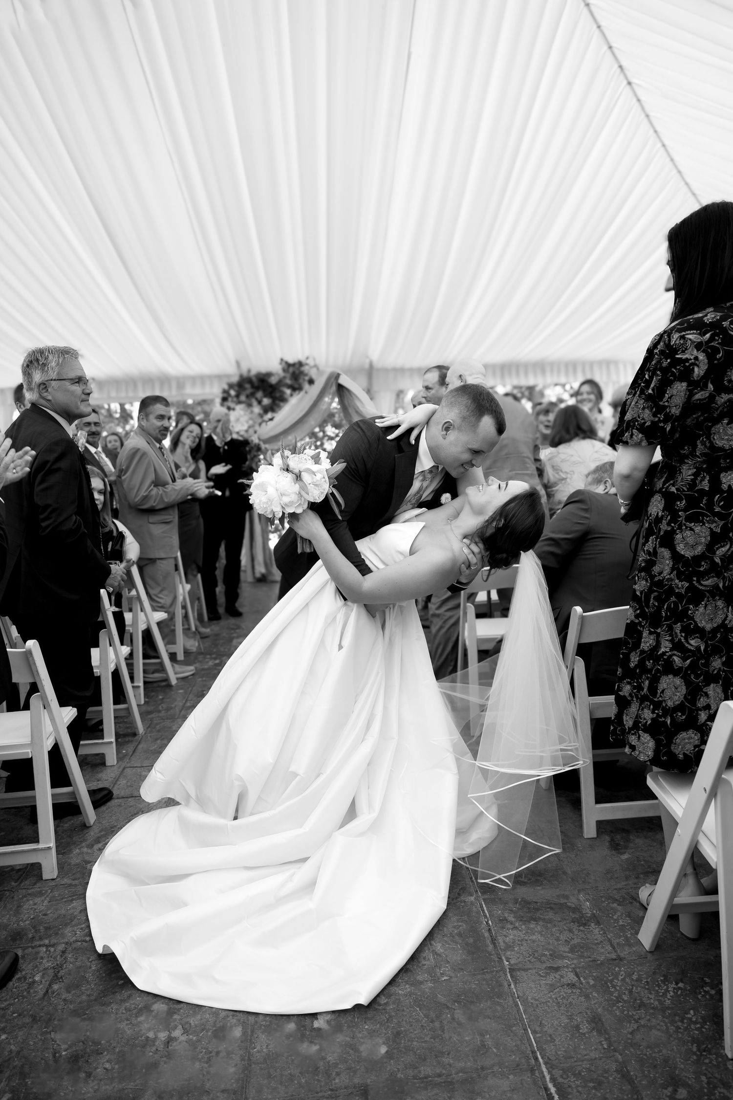 A romantic wedding moment captured in a sequence showing a tender kiss between newlyweds in formal attire.