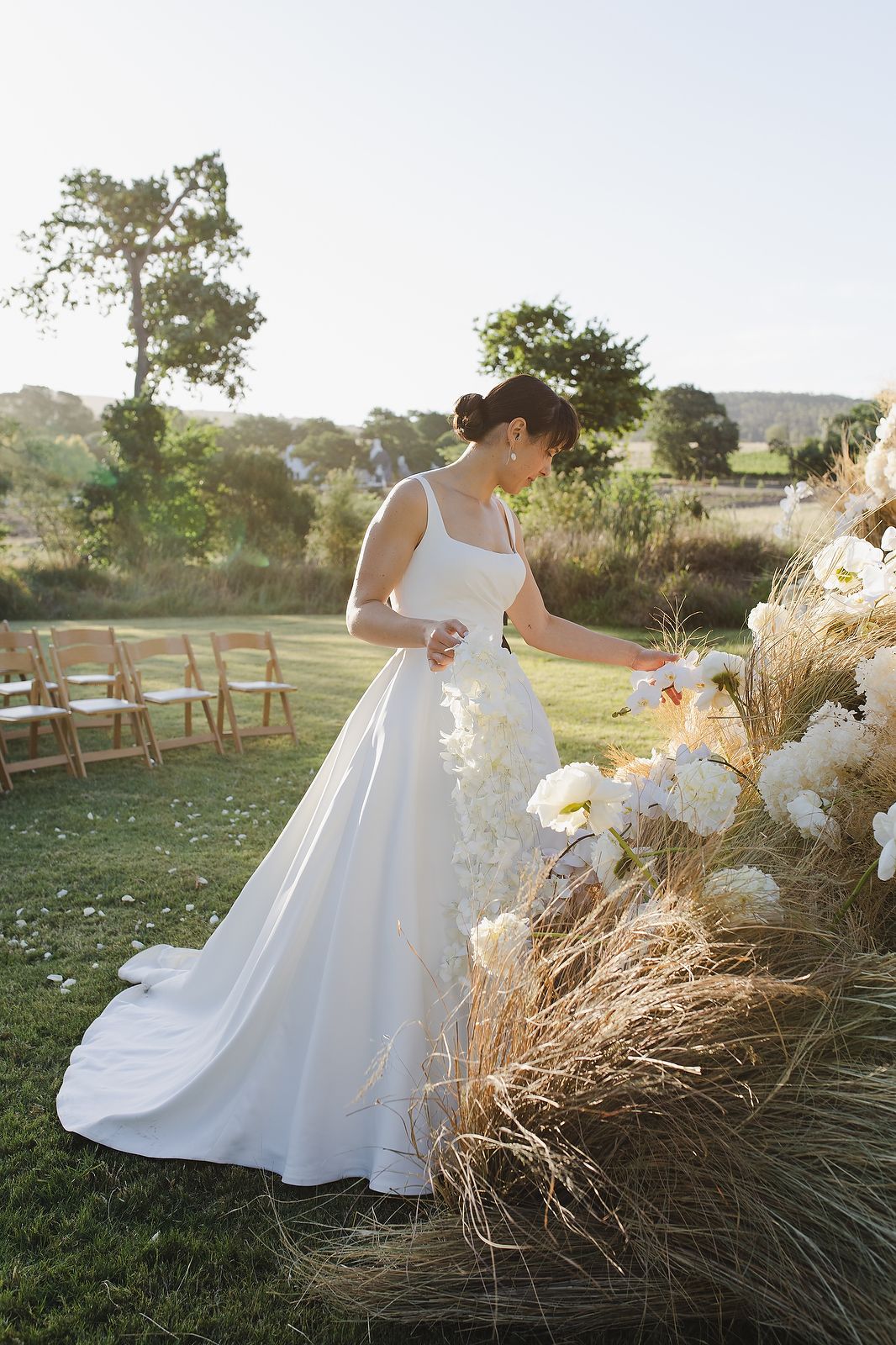 Bride admiring floral arrangements