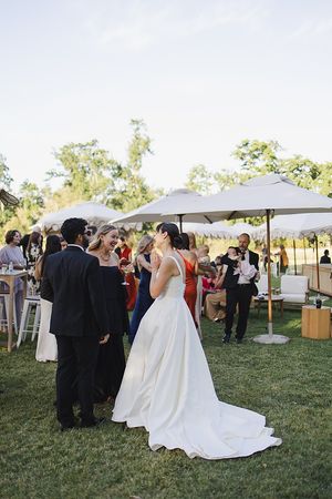 Bride and groom enjoying canapes with their guests.