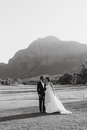 The couple at golden hour with mountain backdrop.