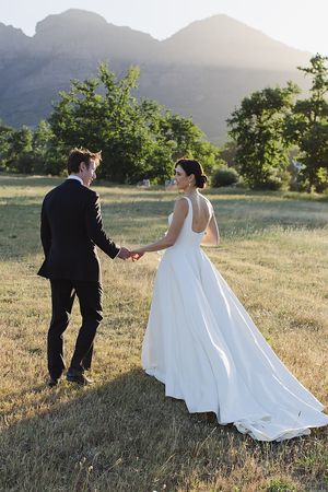 The couple walking at golden hour on Plaisir Wine Estate.