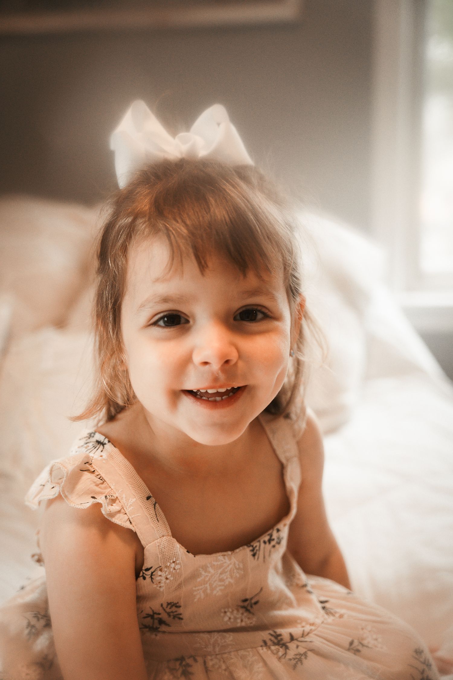 A series of five close-up photos showing a smiling baby wearing a delicate lace dress in soft, natural lighting.