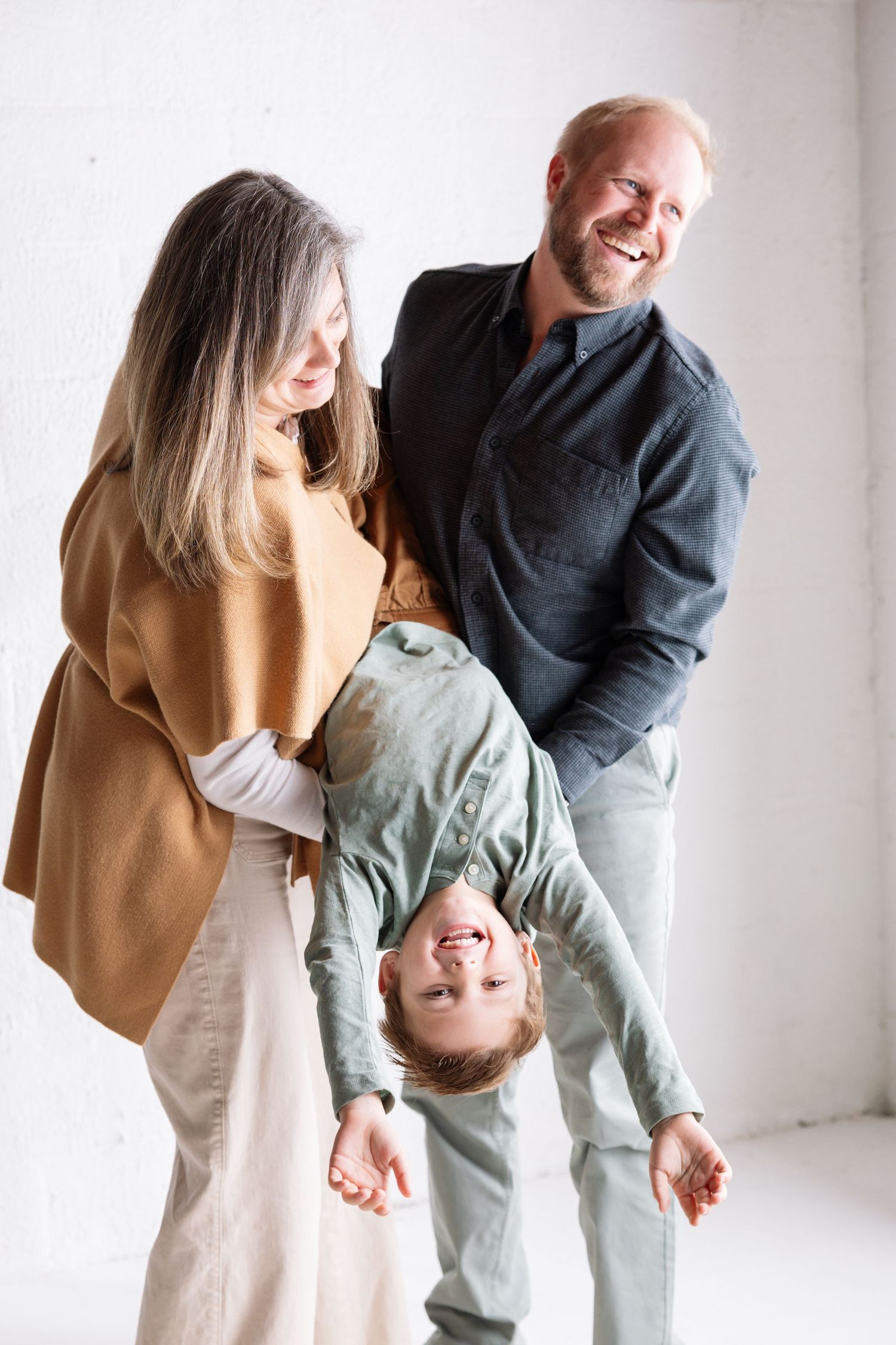 A series of holiday photos showing festive interactions with Santa Claus against a white backdrop with a wreath decoration.