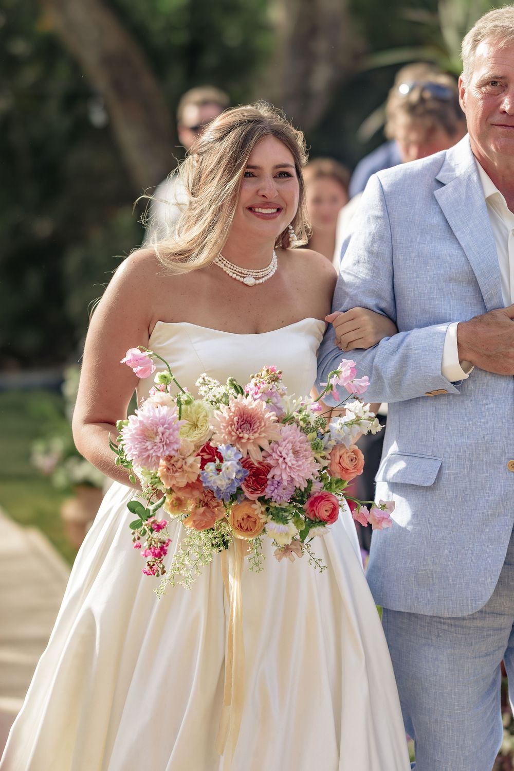 Close-up shots of a wedding couple in cream and gray attire with pink floral bouquets against an outdoor setting.