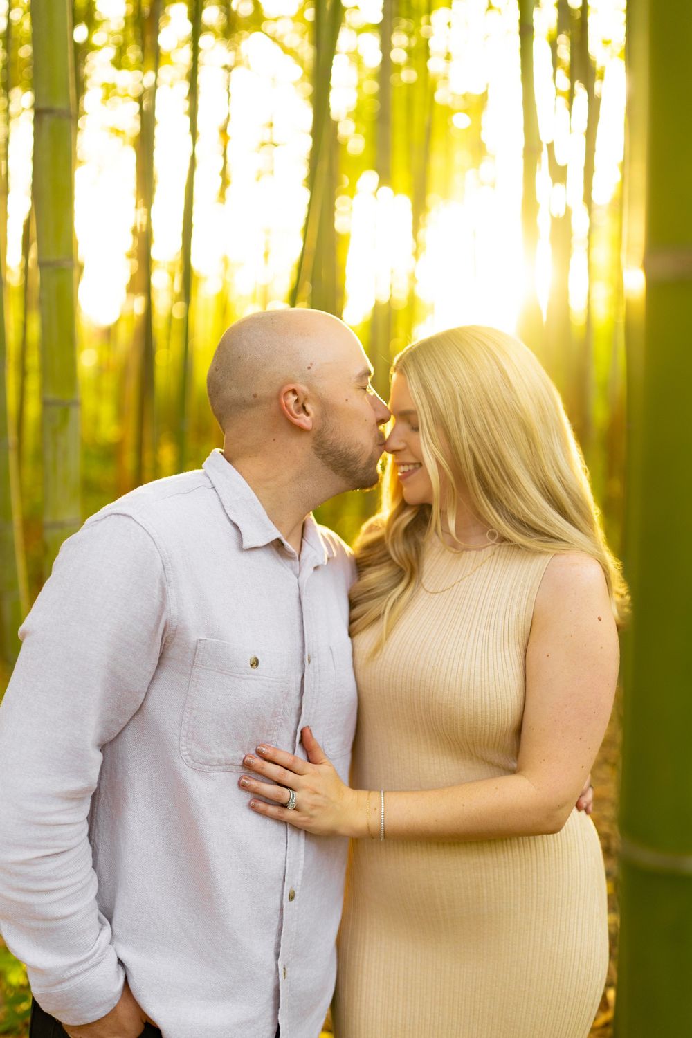 Intimate couple sharing tender moments in a glowing yellow forest setting.