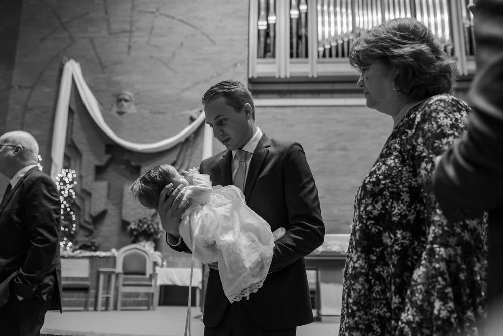 People gathered in formal attire during a baptism service at a church.