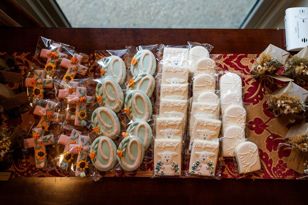 Baptism-themed party favors and decorative items arranged on a table.