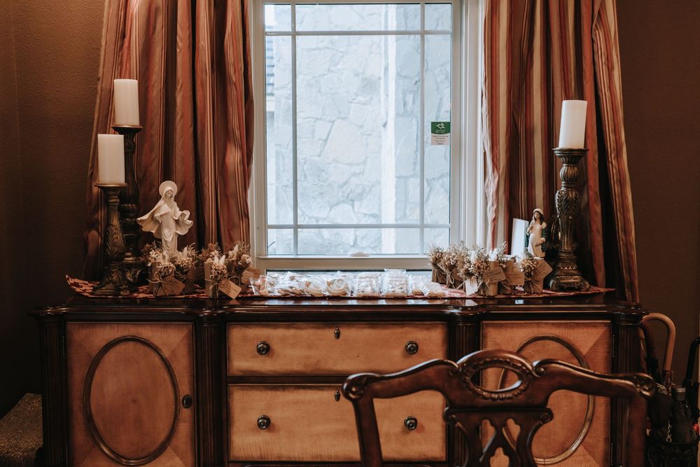 Warm-toned interior view of a window with religious decor and crosses.