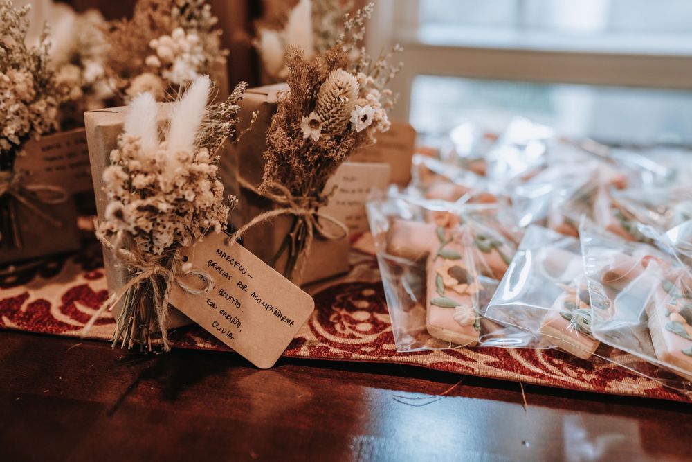 Baptism celebration details with floral arrangements and party favors on display.