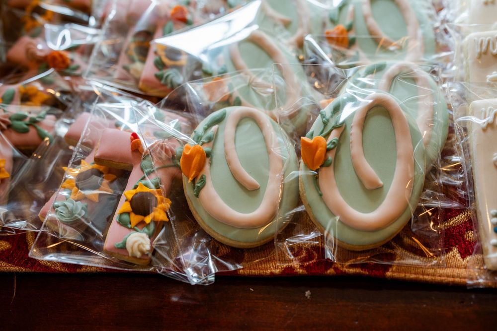 Decorated cookies with mint green frosting wrapped in clear packaging.