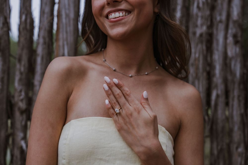 Close-up shots of joyful couple embracing and laughing in a wooded setting.