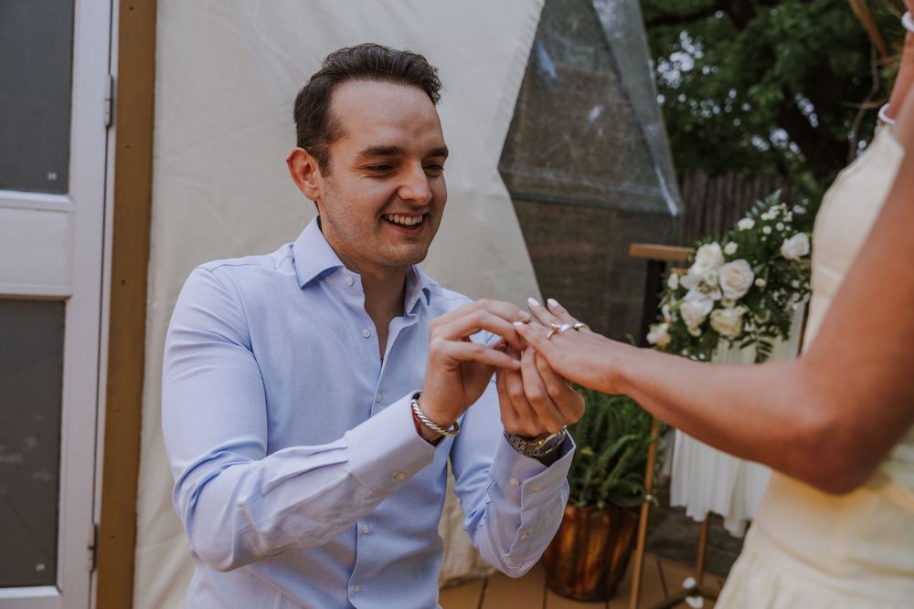 Candid moment between a couple during their garden wedding celebration.