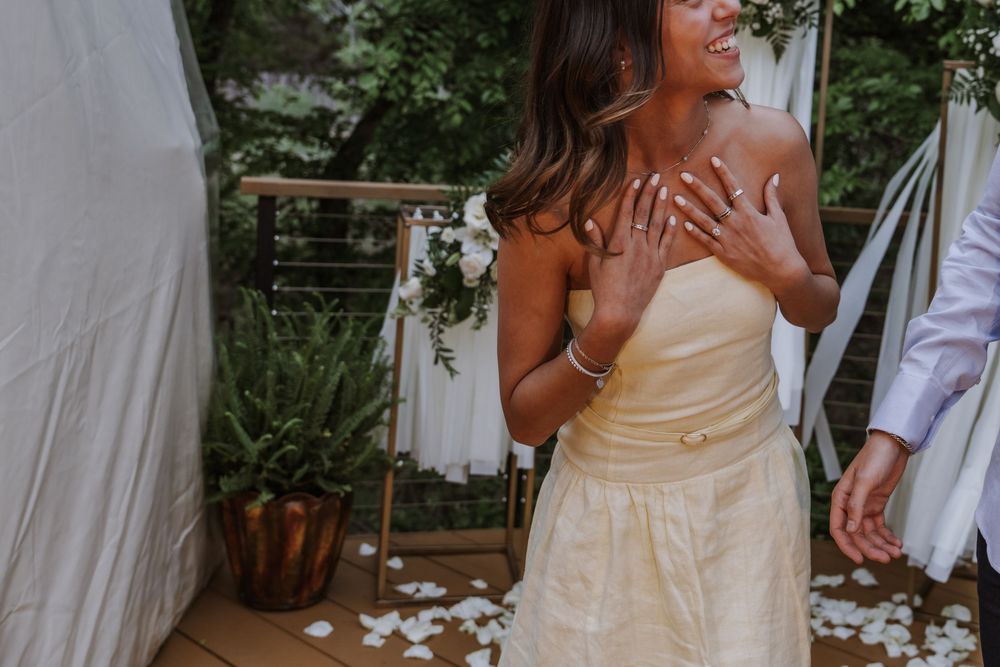Couple in wedding attire sharing intimate moments in an outdoor garden setting.
